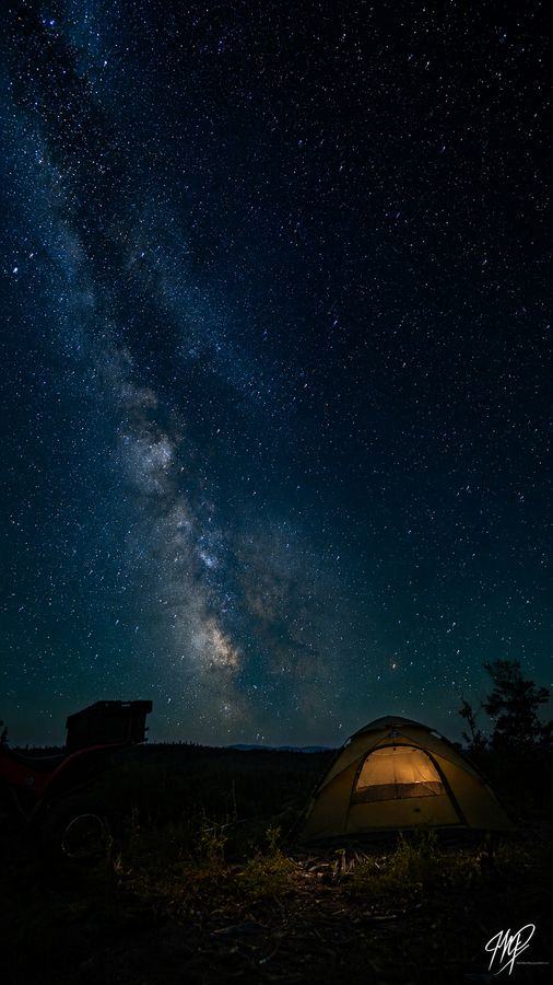 Milky Way above a lit tent