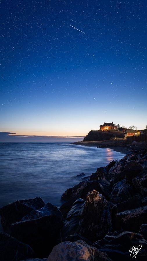 Blue hour on the shore with a shooting star