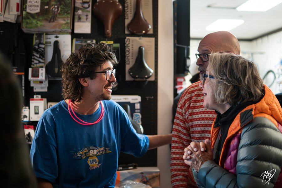 Bike shop employee laughing with customers