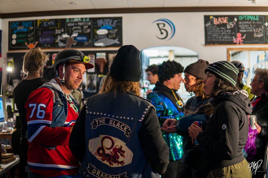 Costumed crowd at a bike shop party